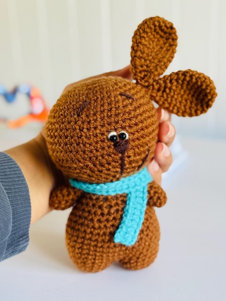Handmade crochet amigurumi bunny held in hand